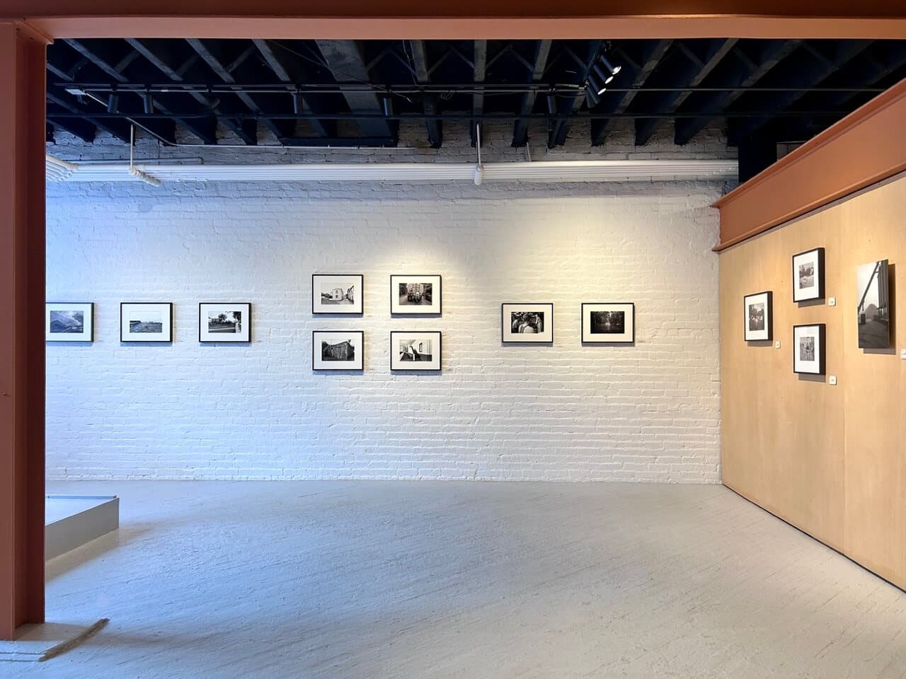 Black-and-white photographs on a gallery wall.